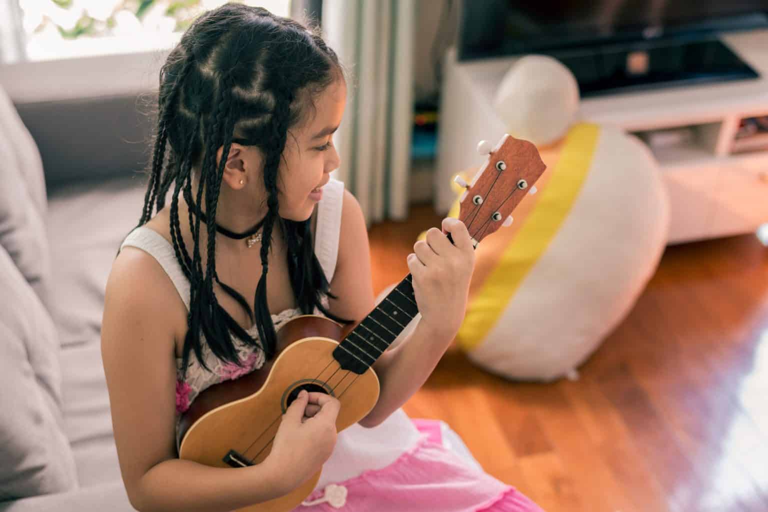 A young student smiling during a private music lesson