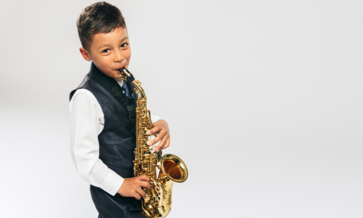 A young student playing an alto saxophone